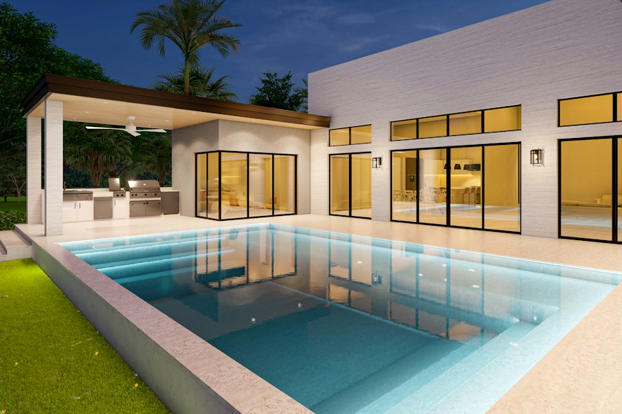 Backyard pool beside a modern home at dusk